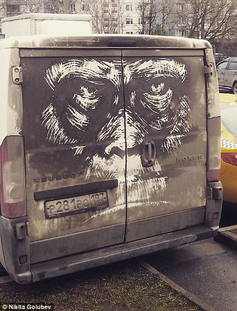 Van with artwork of gorilla drawn in dirt